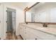 Bathroom featuring a double sink vanity, granite countertops, wood floors, and neutral paint at 2586 Lee Lawing Rd, Lincolnton, NC 28092