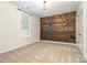 Bright bedroom featuring carpet floors, a modern light fixture, and a unique wood accent wall at 2586 Lee Lawing Rd, Lincolnton, NC 28092
