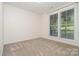 Bedroom featuring two windows with blinds and neutral carpet at 2586 Lee Lawing Rd, Lincolnton, NC 28092