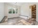 Light-filled dining room boasts shiplap walls, wood flooring, built in bench, and stylish lighting fixtures at 2586 Lee Lawing Rd, Lincolnton, NC 28092