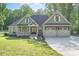 Charming home featuring a well-manicured lawn and a three-car garage at 2586 Lee Lawing Rd, Lincolnton, NC 28092