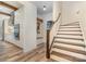 Hallway with wood flooring, a staircase with wooden banisters, and adjacent kitchen at 2586 Lee Lawing Rd, Lincolnton, NC 28092
