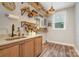 Laundry room with wood flooring, shelving, and granite countertop sink at 2586 Lee Lawing Rd, Lincolnton, NC 28092