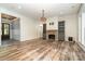 Open-concept living room with fireplace, built-ins, and wood-look floors at 2586 Lee Lawing Rd, Lincolnton, NC 28092