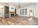 Spacious living room with brick fireplace, built-ins, and wood-look floors at 2586 Lee Lawing Rd, Lincolnton, NC 28092