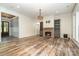 Open-concept living room with fireplace, built-ins, and wood-look floors at 2586 Lee Lawing Rd, Lincolnton, NC 28092
