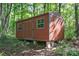 A red storage shed with painted trim is a great backyard solution for extra storage at 2586 Lee Lawing Rd, Lincolnton, NC 28092
