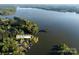 Aerial view of waterfront property and neighborhood highlighting lake access and lush surroundings at 264 Fairway Shores Rd, Mount Gilead, NC 27306