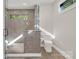 Tiled bathroom featuring glass shower, window, and toilet at 264 Fairway Shores Rd, Mount Gilead, NC 27306