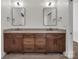 Bathroom showcasing a wood vanity with double sinks, mirrors, and modern fixtures at 264 Fairway Shores Rd, Mount Gilead, NC 27306