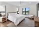 Bright bedroom with waterfront view, lake view, hardwood floors, and a cozy chair near the window at 264 Fairway Shores Rd, Mount Gilead, NC 27306