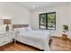 Bright bedroom with hardwood floors, ceiling fan, and a large window view at 264 Fairway Shores Rd, Mount Gilead, NC 27306