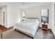 Bright bedroom features hardwood floors, a ceiling fan, two windows, and stylish furnishings at 264 Fairway Shores Rd, Mount Gilead, NC 27306