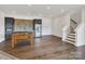 Spacious bonus room with a foosball table, bar area, and stairs to the upper level at 264 Fairway Shores Rd, Mount Gilead, NC 27306