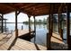 Covered boat dock on a serene lake with calm water, providing a tranquil waterfront experience at 264 Fairway Shores Rd, Mount Gilead, NC 27306