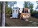 Exterior shot of the house with a deck, modern design, and landscaped yard at 264 Fairway Shores Rd, Mount Gilead, NC 27306