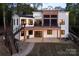 Modern home featuring a deck, white siding, black trim, outdoor stairs and a stone path at 264 Fairway Shores Rd, Mount Gilead, NC 27306