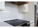 Close up of the kitchen featuring sleek white backsplash tiles, quartz countertops, and stainless steel appliances at 264 Fairway Shores Rd, Mount Gilead, NC 27306