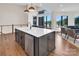 Stylish kitchen with quartz island, stainless appliances, and hardwood floors, blending elegance and functionality at 264 Fairway Shores Rd, Mount Gilead, NC 27306