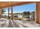 Beautiful lake view from a covered patio with a wood ceiling and gray concrete floors at 264 Fairway Shores Rd, Mount Gilead, NC 27306