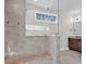 Walk-in shower showcasing stone bench and backsplash, as well as glass door and window at 264 Fairway Shores Rd, Mount Gilead, NC 27306
