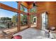 Wood-paneled sunroom offering large windows with views of the lake and outdoor spaces at 264 Fairway Shores Rd, Mount Gilead, NC 27306