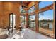 Bright sunroom with wood-paneled walls, tile floors, and windows providing picturesque lake views at 264 Fairway Shores Rd, Mount Gilead, NC 27306