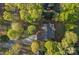 An aerial view of a home with a deck, lush landscaping, and a long driveway at 300 Yacht Rd, Mooresville, NC 28117