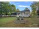 Serene backyard with a deck, screened in porch, fire pit and outdoor seating to enjoy the outdoor living at 300 Yacht Rd, Mooresville, NC 28117