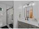 Bright bathroom featuring a glass enclosed shower, black fixtures, and white marble countertops and floors at 300 Yacht Rd, Mooresville, NC 28117