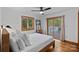 Bright bedroom featuring hardwood floors, a ceiling fan, a bed, and a sliding glass door to a deck at 300 Yacht Rd, Mooresville, NC 28117