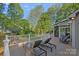 Spacious deck features lounge chairs, outdoor seating and scenic backyard views with lush green trees at 300 Yacht Rd, Mooresville, NC 28117
