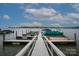 Picturesque dock featuring multiple boat slips on a tranquil lake with clear blue skies at 300 Yacht Rd, Mooresville, NC 28117