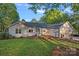 Charming single-story home boasts a manicured front lawn, complemented by lush landscaping and a welcoming walkway at 300 Yacht Rd, Mooresville, NC 28117