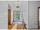 Inviting foyer with hardwood floors, decorative front door and bench seating, creating a warm welcome at 300 Yacht Rd, Mooresville, NC 28117