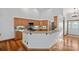 A bright kitchen features wood cabinets, granite counters, stainless appliances, and hardwood floors at 300 Yacht Rd, Mooresville, NC 28117