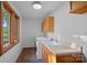 Well-lit laundry room features warm wood cabinets, a sink, a window, and a washer and dryer at 300 Yacht Rd, Mooresville, NC 28117