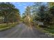 Scenic street view of the neighborhood, lined with mature trees, near the Lake Norman Yacht Club at 300 Yacht Rd, Mooresville, NC 28117