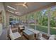 Inviting sunroom featuring wicker furniture, ceiling fans, and floor-to-ceiling windows with tranquil backyard views at 300 Yacht Rd, Mooresville, NC 28117