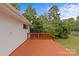 Back of the house featuring a wood deck painted red and green backyard at 3108 Anne St, Charlotte, NC 28205