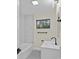 Bathroom with new tile on walls, new flooring and updated fixtures and a window to let in natural light at 3108 Anne St, Charlotte, NC 28205