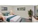 Staged bedroom with a queen sized bed, bedside tables and lamps, and a neutral color scheme at 3108 Anne St, Charlotte, NC 28205