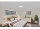 Serene bedroom with neutral walls, hardwood floors, large windows, with stylish furnishings and decor at 3108 Anne St, Charlotte, NC 28205