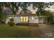 Charming one-story home with white brick, new windows, front yard with green lawn and landscaped features at 3108 Anne St, Charlotte, NC 28205