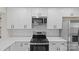 Close up of modern kitchen with stainless steel appliances, white cabinets, and subway tile backsplash at 3108 Anne St, Charlotte, NC 28205