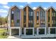 Modern townhome exteriors with mixed wood and siding, plus attached garages at 3449 Byrnes St, Charlotte, NC 28205
