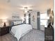 Relaxing bedroom with ceiling fan, two windows, and neutral carpet at 3790 Backwater St, Concord, NC 28027