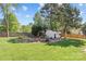 Spacious backyard featuring a playground, shed, and mature trees in a fenced-in yard at 3831 Robeson Creek Dr, Charlotte, NC 28270