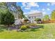 Expansive backyard with a playset, shed, fire pit, and seating area at 3831 Robeson Creek Dr, Charlotte, NC 28270