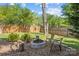 Backyard featuring a fire pit with seating, wooden fence, and mature trees at 3831 Robeson Creek Dr, Charlotte, NC 28270